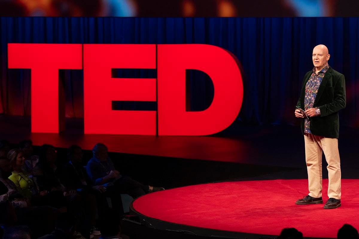 Julian Treasure on the TED stage beside the giant red TED letters