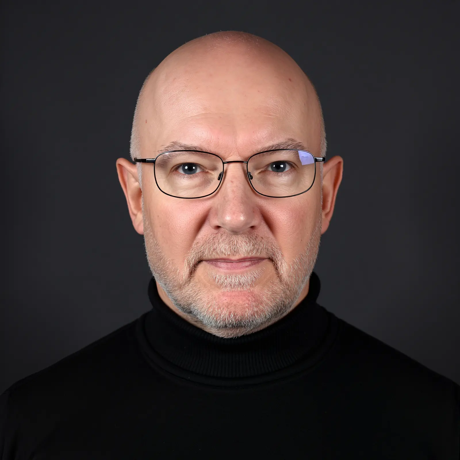 Julian Treasure, head and shoulders, in a black roll-neck against a dark background