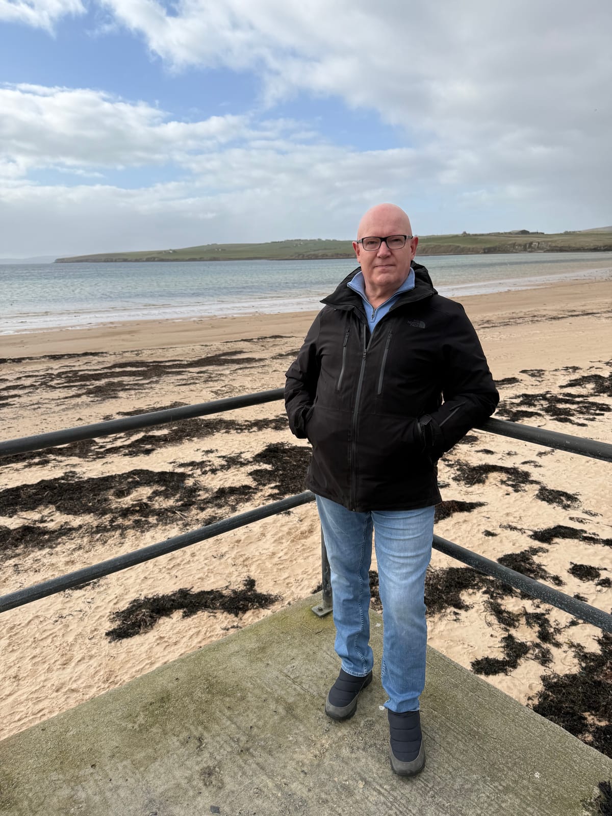 Julian Treasure standing on a beach in Orkney
